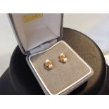 A pair of 9ct gold earrings set with pearls.