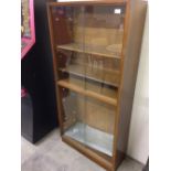 A glass fronted display cabinet. Size 145 x 69cm.