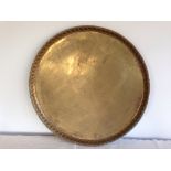 A large brass tray. 66cm diameter.