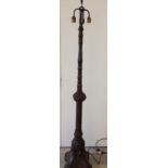 A Black Forest carved wooden standard lamp.