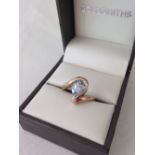 Unusual design blue topaz & diamond ladies ring. Large pearl cut stone approx 0.75ct. Hallmarked 9ct