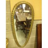 A large gilt framed teardrop/shield shaped mirror. 120cm long.