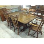 A German solid hardwood dining table with 2 extension pieces and 6 chairs (4 + 2 carvers).