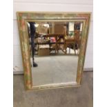 A mirror with flower border 73 x 58cm.