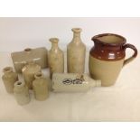 A quantity of old stoneware bottles including 2 lipped oil bottles.