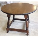 A small oak coffee table with circular top 60cm diameter.