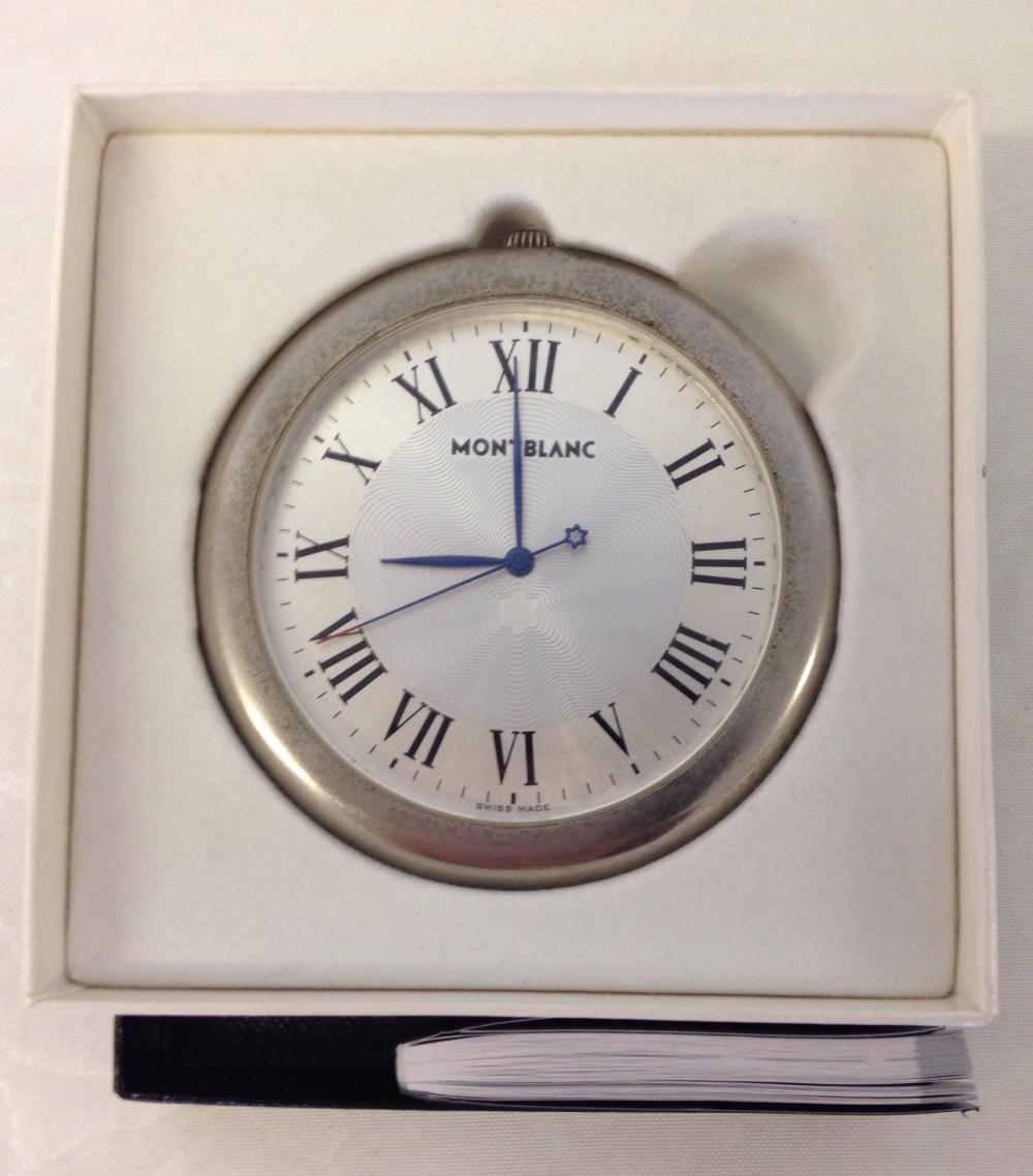 A boxed Mont Blanc desk clock with warranty/service guide.