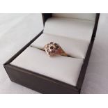 Hallmarked 9ct gold ladies ring set with a central garnet & white stones in a heart shape mount.