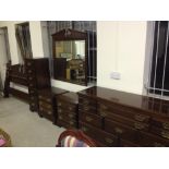 An oak bedroom suite comprising large drawer unit, 2 bedside chests of drawers, tall chest of