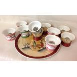 A set of 5 Saki cups on tray with another set of 6, all with glass domed bottom revealing images