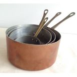 A set of 4 French vintage copper saucepans.