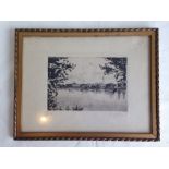 A framed & glazed continental block print of a lake & village signed by A. Gebhard. 24 x 31cm.