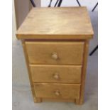 A pine 3 drawer small bedside chest of drawers.