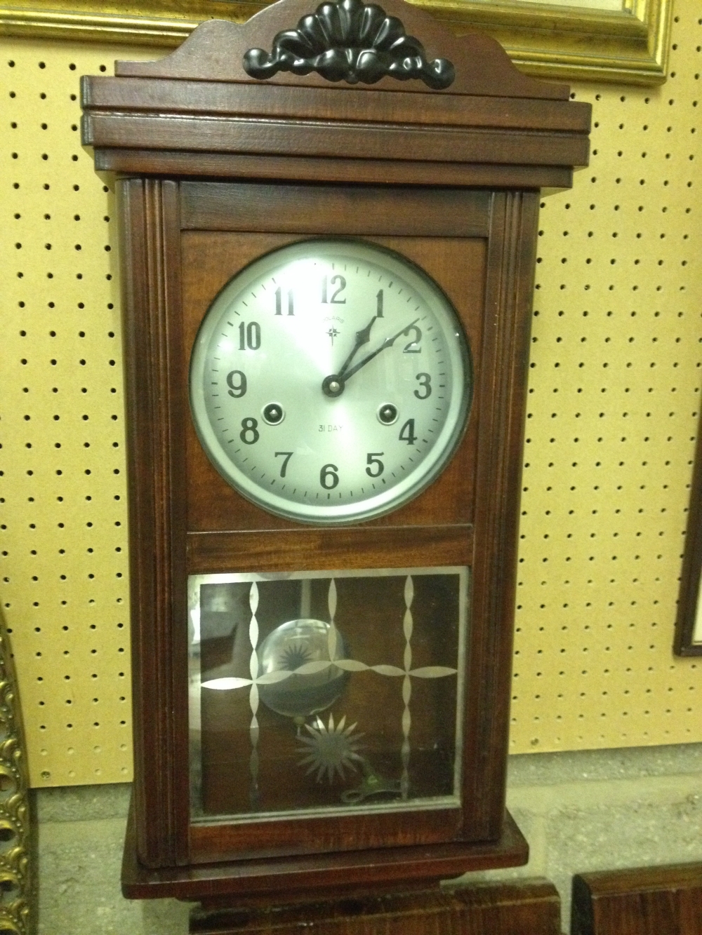 A Polaris 31 day wall clock in working order.