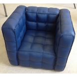 An unused childs blue leather cube armchair.