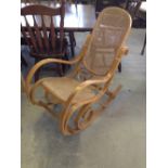 A cane seated & backed rocking chair.