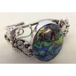 A 925 silver bracelet set with a large paua/abalone shell cabouchon. 3.5cm long.