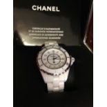 A boxed Chanel J12 ladies white ceramic wristwatch with certificate. Set with 12 diamonds and date