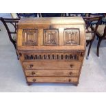 An oak 3 drawer bureau with linen fold carved decoration, 76cm wide.