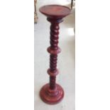 A cherry red stained wooden torchere with twisted stem, 87cm tall.