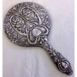 An Art Nouveau HM Silver hand mirror with 'Green Man' & flower decoration. Birmingham 1910, maker