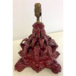 An antique continental majolica table lamp in red glaze, approx 33cm tall.