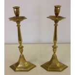 Pair of heavy Victorian ecclesiastic style brass tall candlesticks with drip trays under sconces.