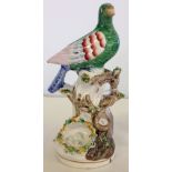 Rare 19th century Staffordshire pottery bird on a branch with nest. Some restoration. 22cm tall.