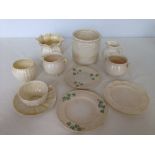 A collection of 12 pieces of Belleek including a jug, sugar bowl & vase.