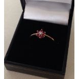 9ct gold ladies ring set with 6 small rubies and a central diamond, size P