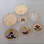 A collection of 7 24ct gold plated coins to include 2 limited edition crowns commemorating the