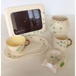 A small collection of Belleek shamrock china to include a photo frame, tennis set, small mug,