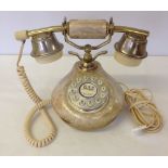 A gold coloured telephone.