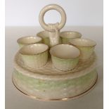 A Belleek egg stand with 6 egg cups, green backstamp.