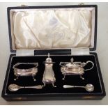 Boxed Elkington silver condiment set. Salt and mustard pots have blue glass liners. All pieces