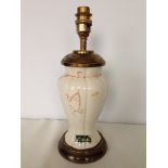 A Belleek china and brass table lamp.