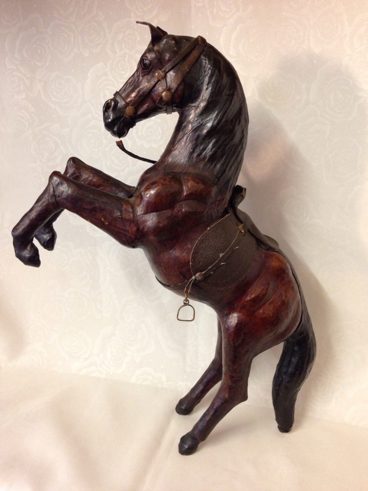 A leather rearing horse model, 38cm tall.