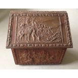 A wooden brass covered log box with horse and groom decoration. Painted gold with some wear.