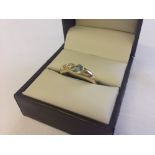 A 9ct gold dress ring set with blue topaz and diamonds, size O.