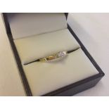 A 9ct gold central diamond ring with small diamonds on shoulders, size N.