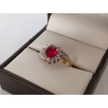 Hallmarked 9ct gold ladies dress ring set with a heart shaped created ruby and 3 small diamonds.