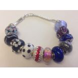 Hallmarked 925 silver bracelet with 11 assorted Murano glass beads.