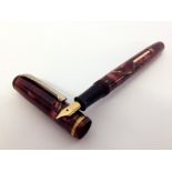Burnham B44 Fountain Pen c1940s.Pink and gold veined marble with rolled gold trim. A lever filler