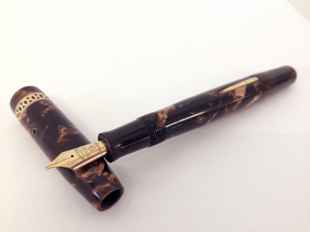 Unique ‘The Unique Pen’ c1950s.Brown and fawn pearlescent marble with rolled gold trim. A lever