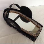 A vintage horse head harness with inset mirror.