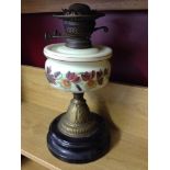 A vintage oil lamp with opaline reservoir decorated with hand painted flowers - no chimney.