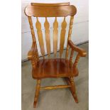 A large modern oak rocking chair.