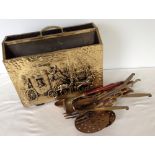 A brass magazine rack & assorted brass spoons and ladles.