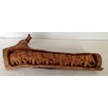 A wood carving of a troop of elephants. 63cm long.
