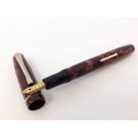 Burnham B49 Fountain Pen c1950s.Pink and Black pearlescent marble with rolled gold trim. A lever
